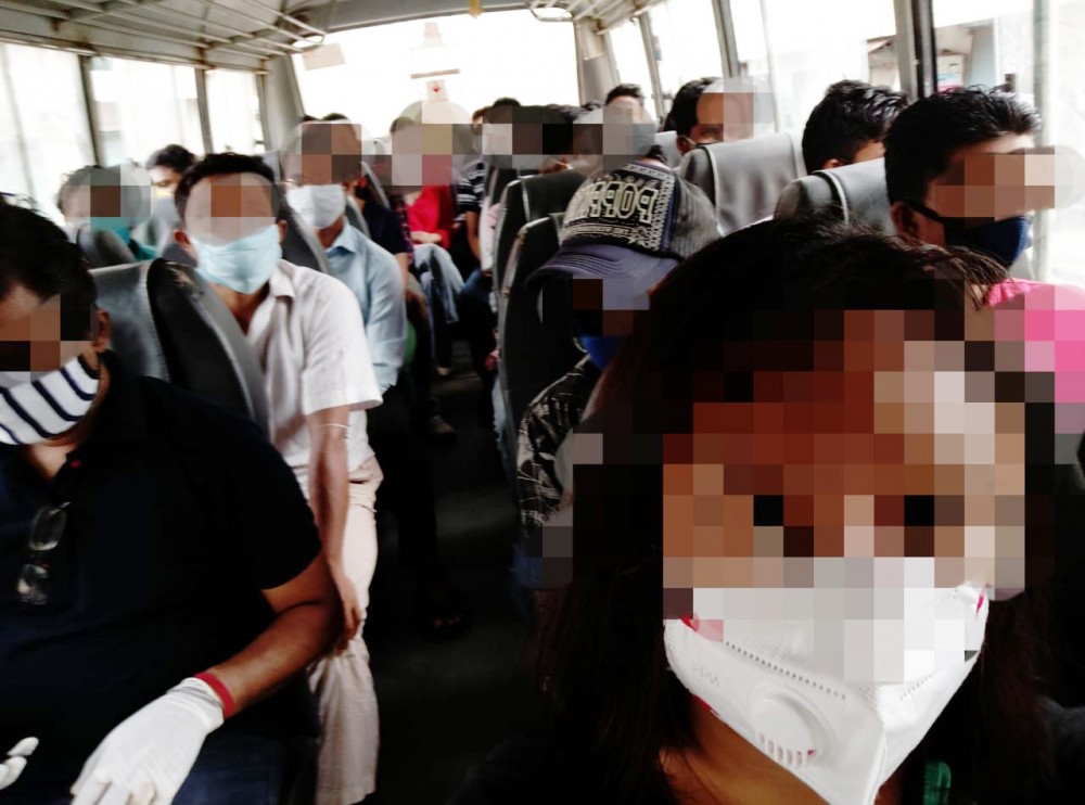 Returnees sitting in close proximity to each other inside the bus while being taken for COVID-19 testing on July 27 in Dimapur. (Photo by Special Arrangement)